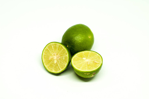 Sliced Fresh Lime with One Behind Isolated in White Background - Photo, image
