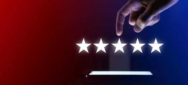 Man finger clicks on the five stars icon.pointing five star symbol to increase rating of company.Review, increase rating or ranking, evaluation and classification concept - Foto, Imagem