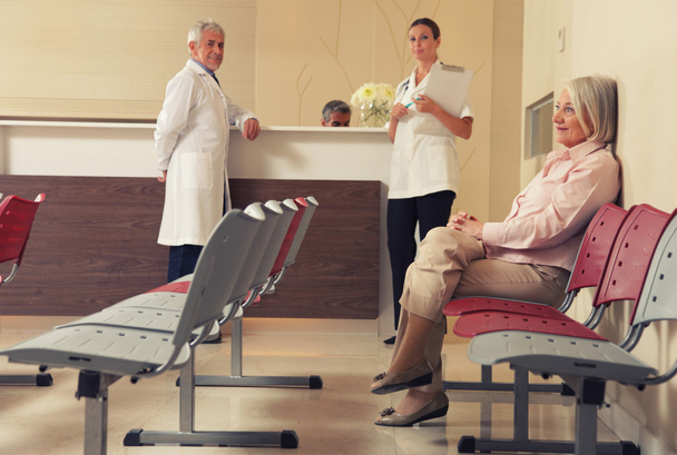 ανώτερος γυναίκα ασθενής κάθεται στην αίθουσα αναμονής νοσοκομείου μαζί μου - Φωτογραφία, εικόνα