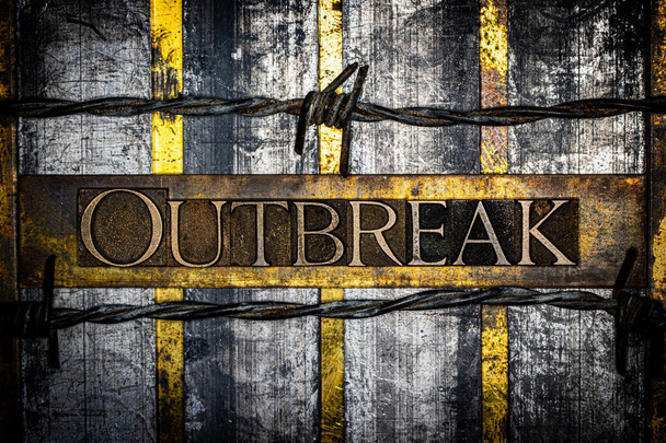 Outbreak text on vintage textured grunge copper and gold steampunk background lined with barbed wire - Photo, Image