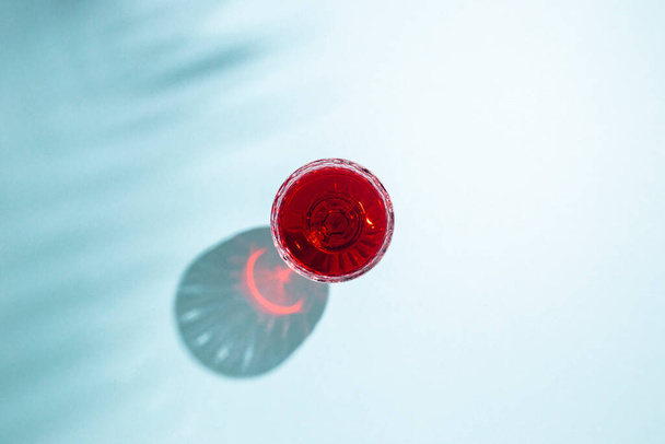 glass with red wine on a blue background. Top view, flat lay. - Foto, immagini