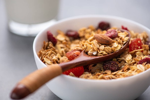 Closeup of granola with nuts and dried fruit. - Photo, Image