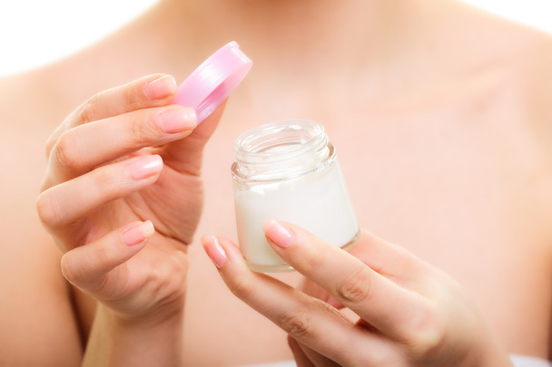 Girl applying moisturizing cream. - Foto, imagen