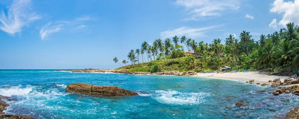 Panoramic view of a small lagoon with traditional wooden fishing boats on the beach in Sri Lanka. - Фото, изображение