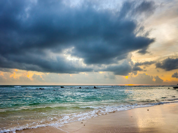 Sunset over the Indian ocean shore in Sri Lanka. - 写真・画像