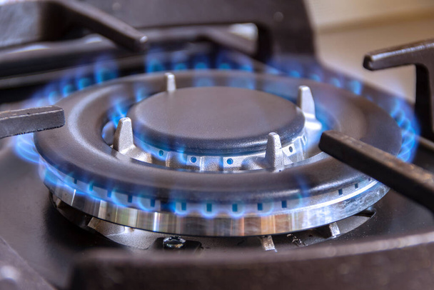 A burning gas burner in the kitchen. The use of natural gas in the household. - Photo, Image