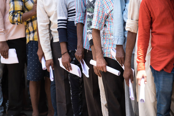MUMBAI/INDIA - MAY 6, 2020: Migrant worker stand in queue to collect doctor certificates to travel back to their homes during nationwide lockdown as a preventive measure against COVID-19 coronavirus - Fotografie, Obrázek
