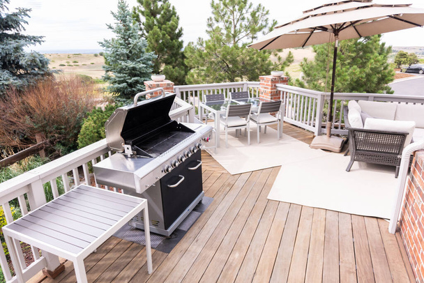 Outdoor six-burner gas grill on the back patio of a luxury single-family home. - Photo, Image