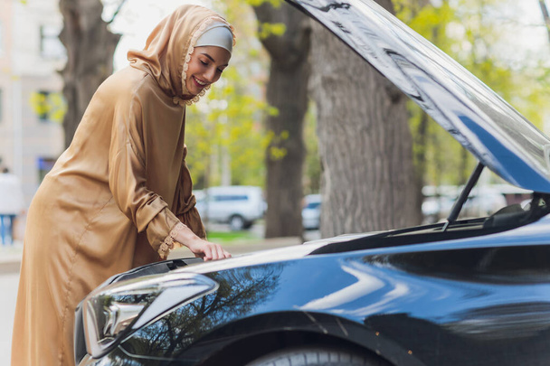 Middle Eastern Woman Driving a Car, Looking Forward. - 写真・画像
