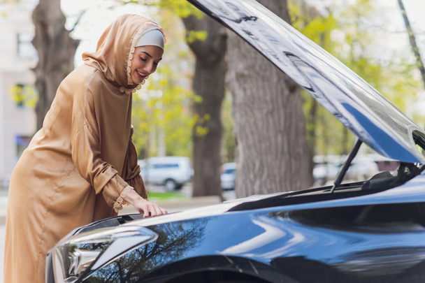 Middle Eastern Woman Driving a Car, Looking Forward. - 写真・画像