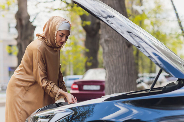 Middle Eastern Woman Driving a Car, Looking Forward. - Фото, зображення