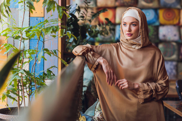 Arabian young muslim woman sitting in a cafe. - Valokuva, kuva