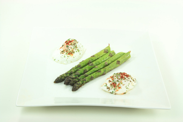 Pictured plate contains Baked Asparagus Spears seasoned with Olive oil, Sea salt, Ground Black Pepper and Poached Eggs seasoned with Paprika, Black Pepper and P - Fotó, kép