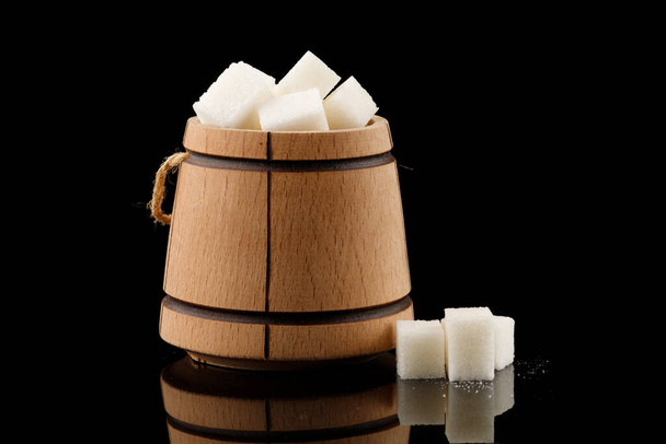 Many pieces of white sugar in a wooden barrel - Photo, Image