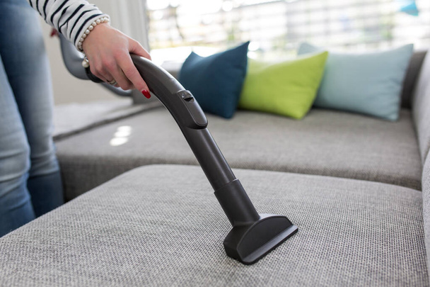 Cleaning the Sofa with Vacuum Cleaner - Foto, Bild