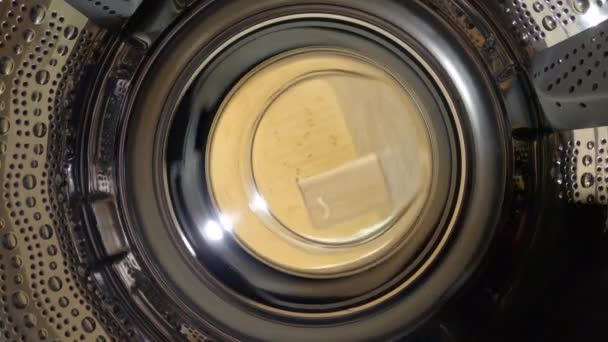 POV: Shot of the inside of a drum as laundry be washed for the weekend - Кадры, видео