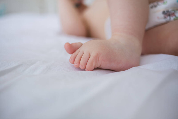 close-up of a toddler's bare feet on a blanket with room for text - Valokuva, kuva