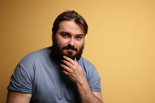 Hipster with beard, posing over yellow background. Isolated. - Φωτογραφία, εικόνα