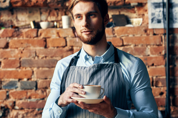 male waiter apron coffee cup work professional cafe - Фото, изображение