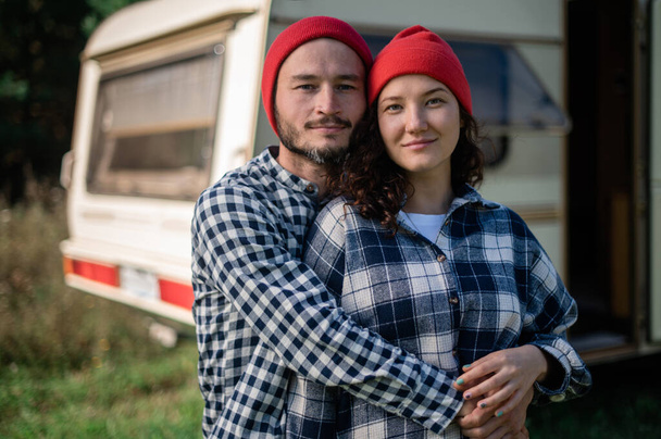 Romantic couple spending time together near trailer home. Traveling together with motor home. - Zdjęcie, obraz