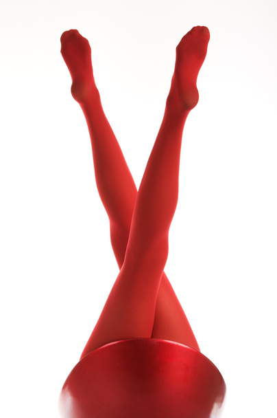 Female feet in red stockings - Фото, изображение
