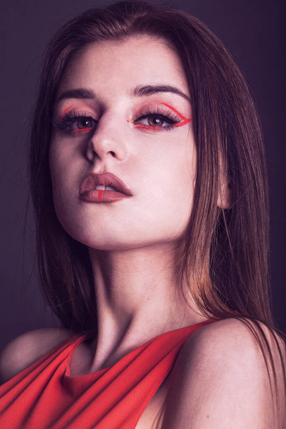 beautiful woman with creative make up in red - 写真・画像