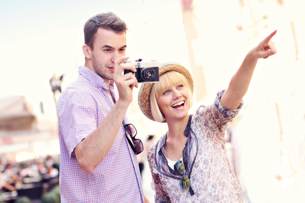 Young couple taking pictures on a tour - Photo, Image