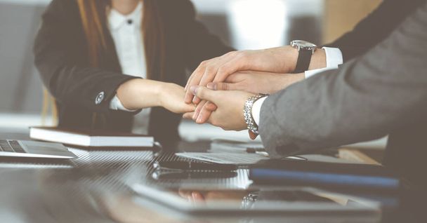 Unknown business people group joining hands in modern office. Businessmen and women making circle with their hands as a team, close-up - Photo, Image
