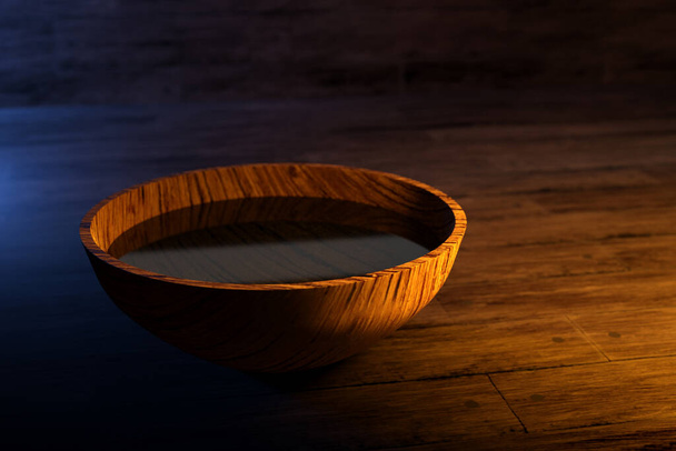 3D απεικόνιση ενός στρογγυλού ξύλινου μπολ με νερό κάτω από κίτρινο φως σε σκούρο φόντο - Φωτογραφία, εικόνα