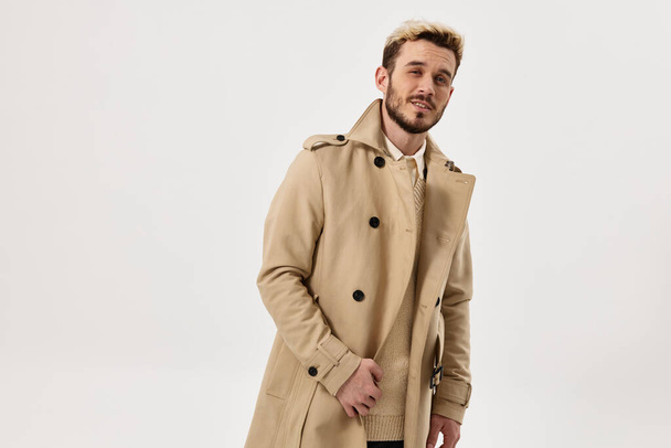 man beige coat hands on the belt look ahead fashionable hairstyle - Photo, Image