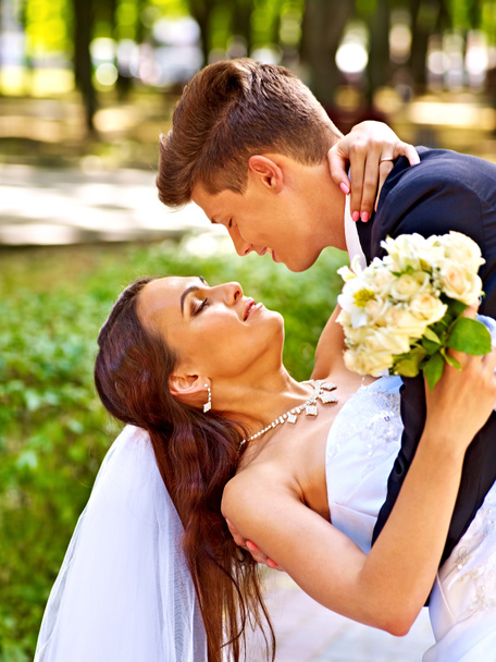 Bride and groom with flowers outdoor. - Photo, Image