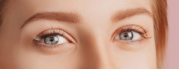 Beautiful sensual young girl with clean skin. Female eyes close-up shot. Woman looking at the camera. The concept of spa treatments, natural beauty and care, youth, cream and mask, freshness - Fotoğraf, Görsel