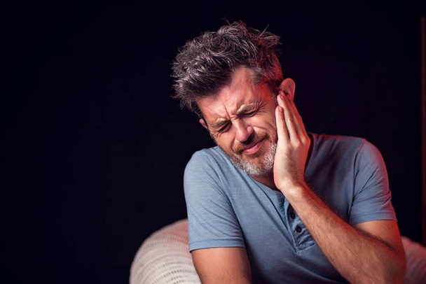 Man feels strong ear ache. People, healthcare and medicine concept - Photo, Image