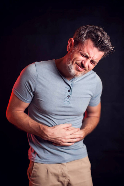 Man feels stomach pain. People, healthcare and medicine concept - Photo, Image