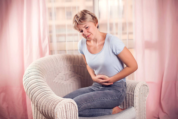 Woman feels strong stomach or period pain. People, healthcare and medicine concept - Photo, Image
