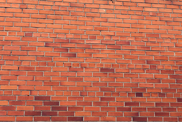 Horizontal red bricks background. A part of wall of the building - Foto, afbeelding