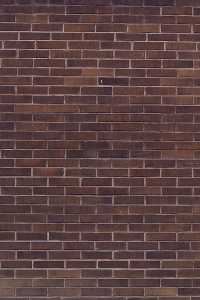 Horizontal black bricks background. A part of wall of the building - Photo, Image