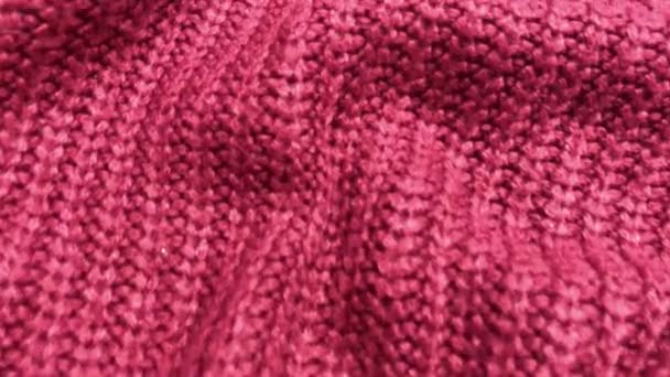 red knitted textile pattern as a background. Close up on red knitted material texture on fabric. crumpled fabric texture - Footage, Video