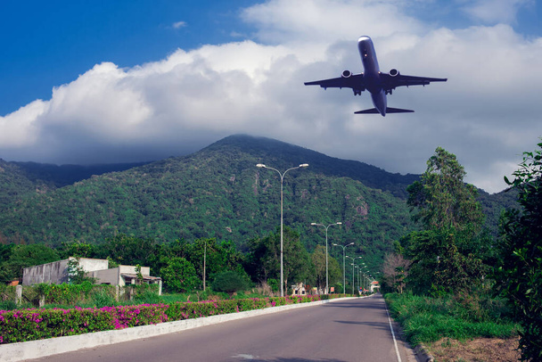 Plane in the sky over mountains. Holiday and travel concept - Photo, Image