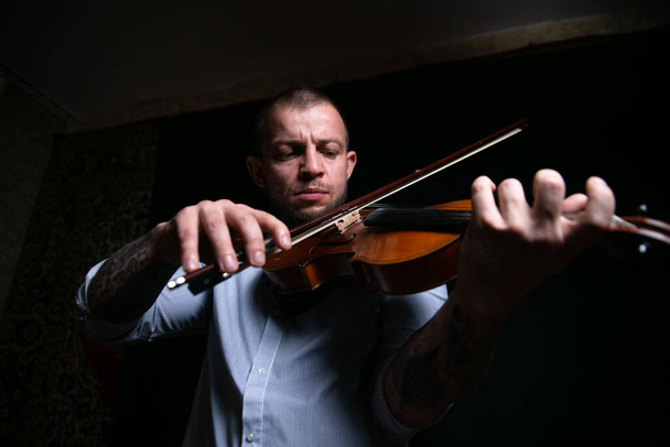 male violinist masterfully plays the violin - Photo, Image