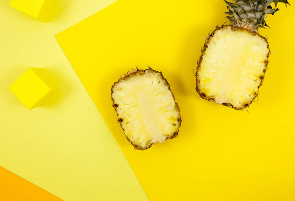 Trendy bright yellow background with geometrical forms and podiums for product presentation. Pineapple and podiums to show products. Summer, holidays, food concept. Flat lay, top view, mock up - Photo, Image