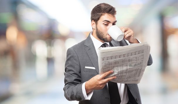 Business man drinking and reading - Zdjęcie, obraz