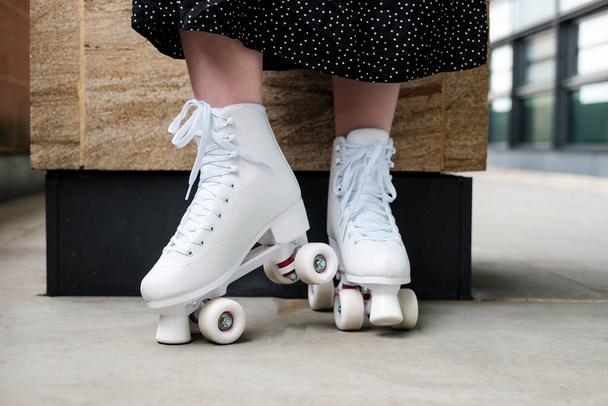Front view of young woman on black skirt roller skating. Close up - Photo, Image