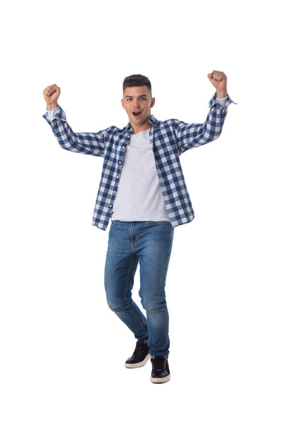 Full length portrait of a young man with arms raised isolated on a white background - Foto, afbeelding