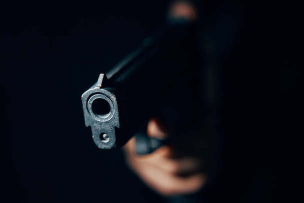 Close-up of black pistol in hand. - Foto, Bild