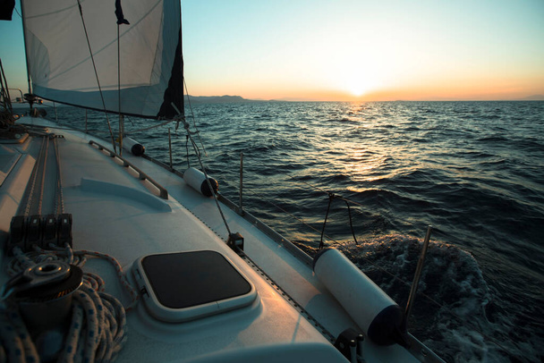Yacht boat in the open Sea during amazing sunset. Luxury Sailing.  - Φωτογραφία, εικόνα