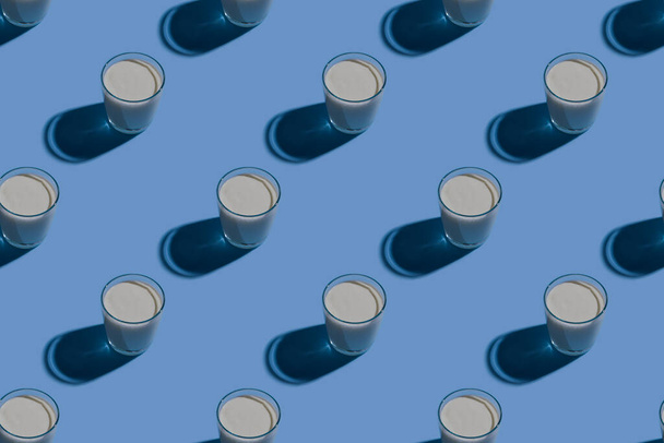 World Milk Day. Pattern on a blue background. A glass of milk. Pattern. - Fotografie, Obrázek