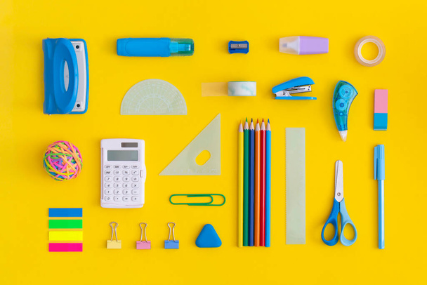 School stationery on a yellow background. Top view. Flat lay. Back to school concept. - Фото, зображення