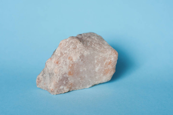 a piece of rock salt on a blue background - Photo, Image