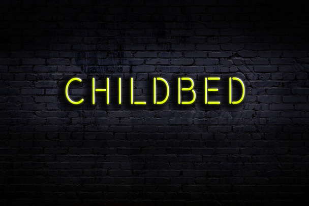 Neon sign on brick wall at night. Inscription childbed - Photo, Image